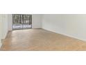 Bright and airy living space with light wood floors, white walls and sliding glass door to the outside at 642 Pine Ridge Pl, Raleigh, NC 27609