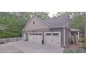 Two-car garage with white doors and a basketball court at 7115 Laurel Point Dr, Gibsonville, NC 27249