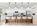 Modern kitchen with large island and white cabinets at 80 Summer Mist Ln # 165P, Clayton, NC 27527