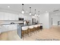 Modern kitchen with island, white cabinets, and stainless steel appliances at 80 Summer Mist Ln # 165P, Clayton, NC 27527