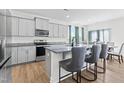 Modern kitchen featuring gray cabinets, granite counters, and stainless steel appliances at 803 Golden Plum Ln, Zebulon, NC 27597