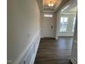 Entryway features decorative molding, dark hardwood flooring and a white front door at 85 N Stagecoach Dr, Wendell, NC 27591