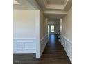 Welcoming entryway displaying wainscoting, hardwood floors, and access to the main living areas at 85 N Stagecoach Dr, Wendell, NC 27591