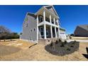 A side view of the exterior showing off the yard space and front entrance with a covered porch at 85 N Stagecoach Dr, Wendell, NC 27591