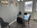 Small dining area with glass table and four gray chairs at 1002 Willow Dr # Apt 54, Chapel Hill, NC 27514