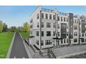 Angle view of the modern townhome exterior showcasing a clean design and rooftop terrace at 101 Ailey Brook Way # 100, Wake Forest, NC 27587
