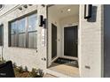 Inviting front entrance with stylish door and brick facade at Stanley Martin Townhomes at 101 Ailey Brook Way # 100, Wake Forest, NC 27587