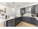 Contemporary kitchen with sleek gray cabinets, stainless steel appliances, and bright lighting at 105 Ailey Brook Way # 100, Wake Forest, NC 27587