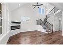 Open living space with hardwood floors, fireplace, and high ceilings at 1064 Jersey St, Haw River, NC 27258