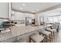 Modern kitchen featuring granite counters, stainless appliances, and seating at island at 109 Ailey Brook Way # 100, Wake Forest, NC 27587