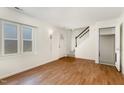 Living area with hardwood floors and access to stairs at 117 London Plain Ct, Cary, NC 27513