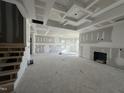 Spacious living room with high ceilings and a fireplace, awaiting finishing touches at 141 Trescott St, Smithfield, NC 27577