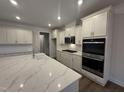 Bright kitchen features quartz countertops, stainless appliances, and ample cabinet space at 15 Long Needle Ct # 38, Youngsville, NC 27596