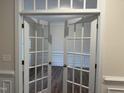 Bright office space featuring glass panel doors, classic trim, and hardwood floors at 15 Long Needle Ct # 38, Youngsville, NC 27596