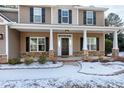 House entrance with stone accents, a dark door, and covered porch at 157 Winston Pointe Dr, Clayton, NC 27520