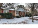 Brick ranch home with red shutters and gray accents, snow covered yard at 201 Providence Rd, Oxford, NC 27565