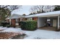 Brick ranch home with gray siding, covered porch, and snow-covered yard at 201 Providence Rd, Oxford, NC 27565