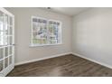 Bright home office with wood-look floors and a large window at 2557 Summersby Dr, Mebane, NC 27302