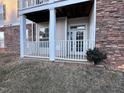 Private patio with white railings and columns at 3015 Winston Dr # Apt 102, Burlington, NC 27215