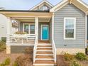 Gray craftsman style home with a teal door and wooden steps at 54 Cottage Way Way, Pittsboro, NC 27312