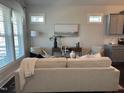 Stylish living room with a modern sofa, elegant decor, and plenty of natural light at 54 Cottage Way Way, Pittsboro, NC 27312
