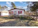 Exterior shot showing a single story home with a deck, red shutters, and gray paint at 602 E Club Blvd, Durham, NC 27704
