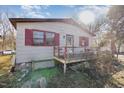 Side view of a ranch home with red shutters and deck at 602 E Club Blvd, Durham, NC 27704