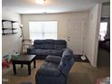 Living room with blue reclining sofas and a coffee table at 670 Meadowtop Cir, Burlington, NC 27217