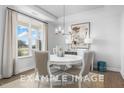 Bright dining room featuring a modern chandelier and large windows overlooking the yard at 71 Priming Way, Angier, NC 27501