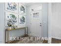 Bright entryway with elegant decor and a stylish console table under decorative prints at 71 Priming Way, Angier, NC 27501