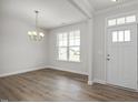 Inviting entryway featuring new hard wood floors, large windows, modern lighting and neutral paint at 71 Priming Way, Angier, NC 27501