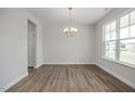 Inviting entryway featuring new hard wood floors, large windows, modern lighting and neutral paint at 71 Priming Way, Angier, NC 27501