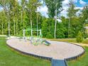 Outdoor fitness and playground area with wood chips at 712 Georgias Landing Pkwy # 13, Raleigh, NC 27603