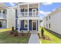 Close up of a blue two-story home featuring a cozy front porch and well-kept landscaping at 720 Georgias Landing Pkwy # 11, Raleigh, NC 27603