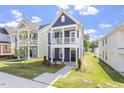 A vibrant blue two-story home with a charming white balcony and lush green lawn at 720 Georgias Landing Pkwy # 11, Raleigh, NC 27603