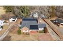 Aerial view showing house, yard, detached garage, and surrounding area at 801 Williamsboro St, Oxford, NC 27565