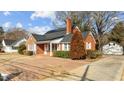 Brick house with solar panels, landscaped yard, and brick driveway at 801 Williamsboro St, Oxford, NC 27565
