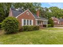 A well-kept brick home with solar panels and white trim at 801 Williamsboro St, Oxford, NC 27565