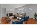 Living room with fireplace, hardwood floors, and staged furniture at 801 Williamsboro St, Oxford, NC 27565