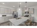 Kitchen island with granite countertop, double sink, and bar seating at 1013 Freestone Rd, Durham, NC 27703