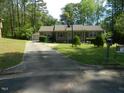 Inviting single-story home features a long driveway, and verdant lawn at 108 Cheney Ct, Garner, NC 27529