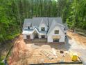 Expansive aerial view of a two-story home showcases its roofline, surroundings, and exterior under construction at 1236 Perry Bluff Dr, Wake Forest, NC 27587