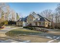 Stunning home with stone exterior and circular driveway at 1313 Enderbury Dr, Raleigh, NC 27614