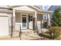 Inviting front porch with stone columns and a charming entryway at 1617 Old Bramble Ln, Fuquay Varina, NC 27526