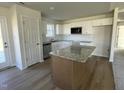 Modern kitchen with granite countertops, white cabinets, and a large island at 164 Phil Jack Rd, Dunn, NC 28334