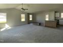 Spacious living room featuring high ceilings, neutral carpeting, and ample natural light at 164 Phil Jack Rd, Dunn, NC 28334