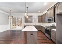 Modern kitchen with gray cabinets, white countertops, and island at 172 Cotten Dr, Morrisville, NC 27560