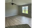 Bright living room featuring hardwood floors and a ceiling fan for comfortable living at 185 N Movado Trl, Kenly, NC 27542