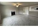 Spacious living room featuring a fireplace and carpet flooring at 209 Constellation Ct, Benson, NC 27504