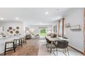 Open concept dining area with hardwood floors and modern table at 2180 Monk Dr, Haw River, NC 27258